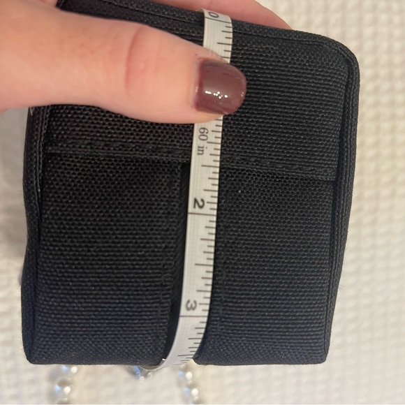 Dior black “CD” raised emblem silver & pearl wristlet & carriage keychain
